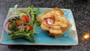 Chilli Lime garlic Prawns served on phyllo pastry topped with Pistachio sweet chilli mayo sauce